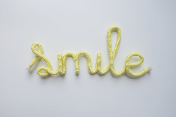 Smile wire word sign wall art